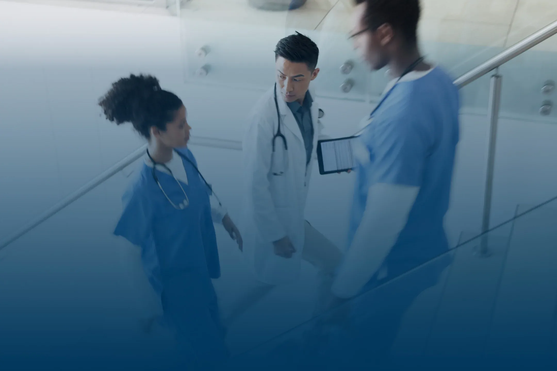 male and female hospital providers walking up stairs