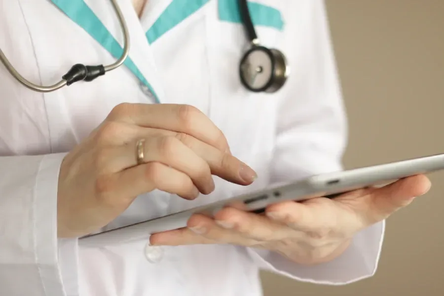 A physician accesses case information on a tablet.