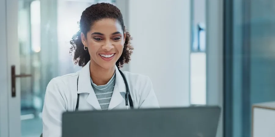 A physician works on a computer.